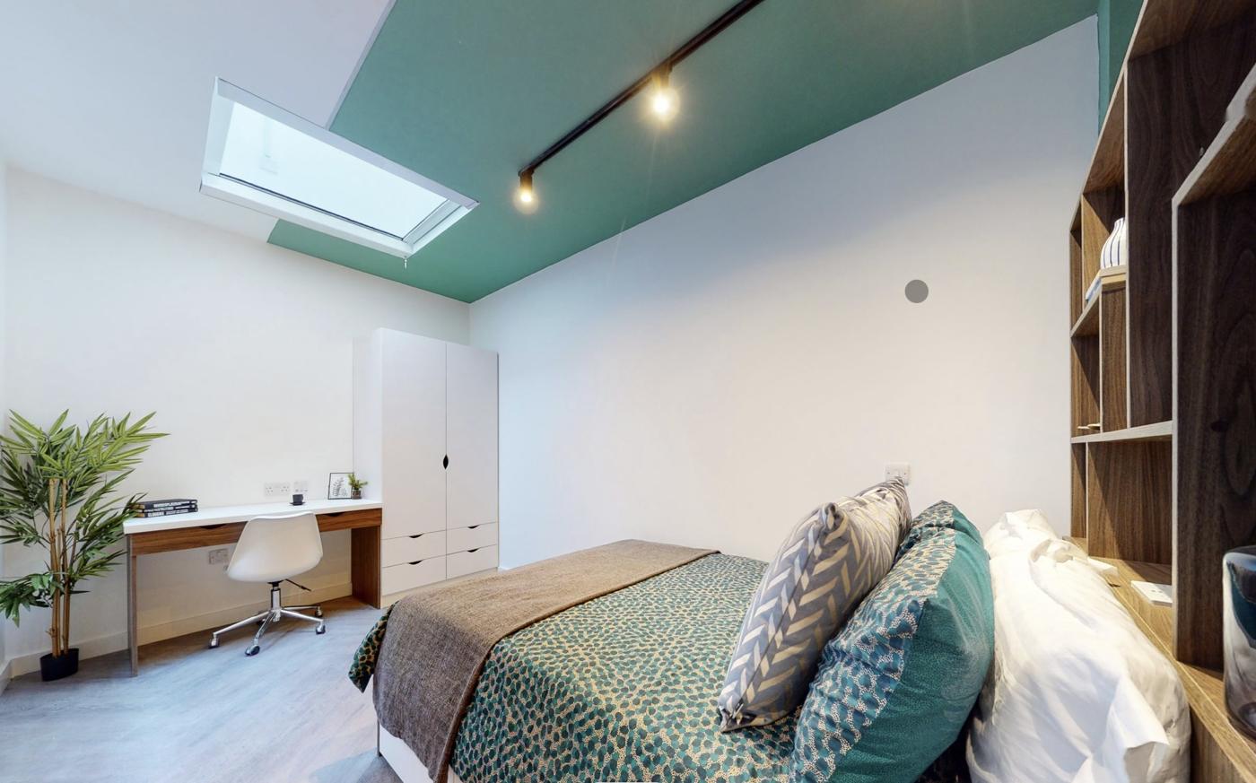 Castello Court student bedroom with walnut shelving, white wardrobe and desk