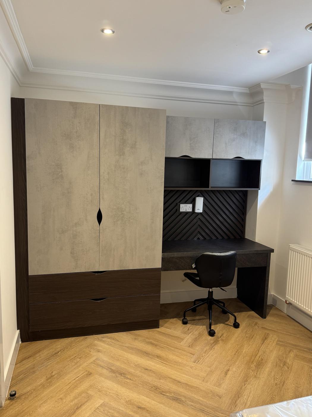 Cookridge Street student room with concrete-effect wardrobe, dark wood drawers and desk with chevron slat panel