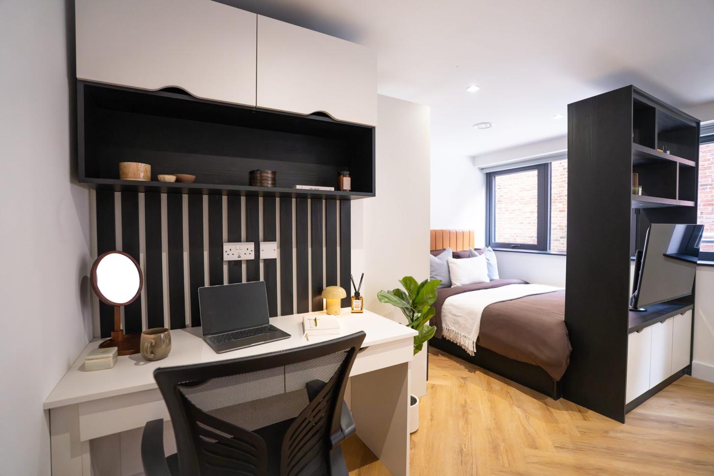 New Walk studio desk with black slatted wall panel, open shelf and white wall cupboards